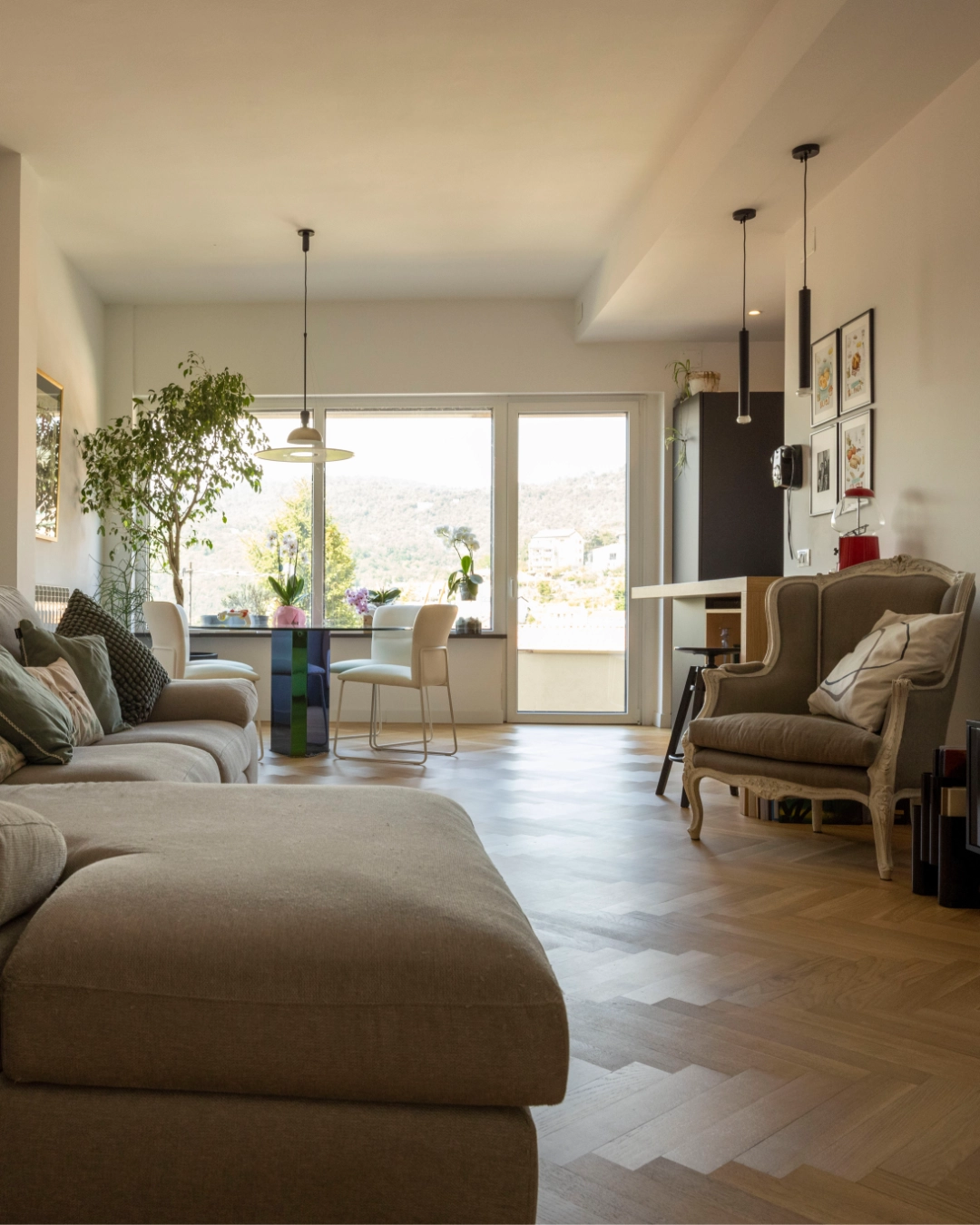 Living con parquet a spina di pesce e finestrone sulla collina